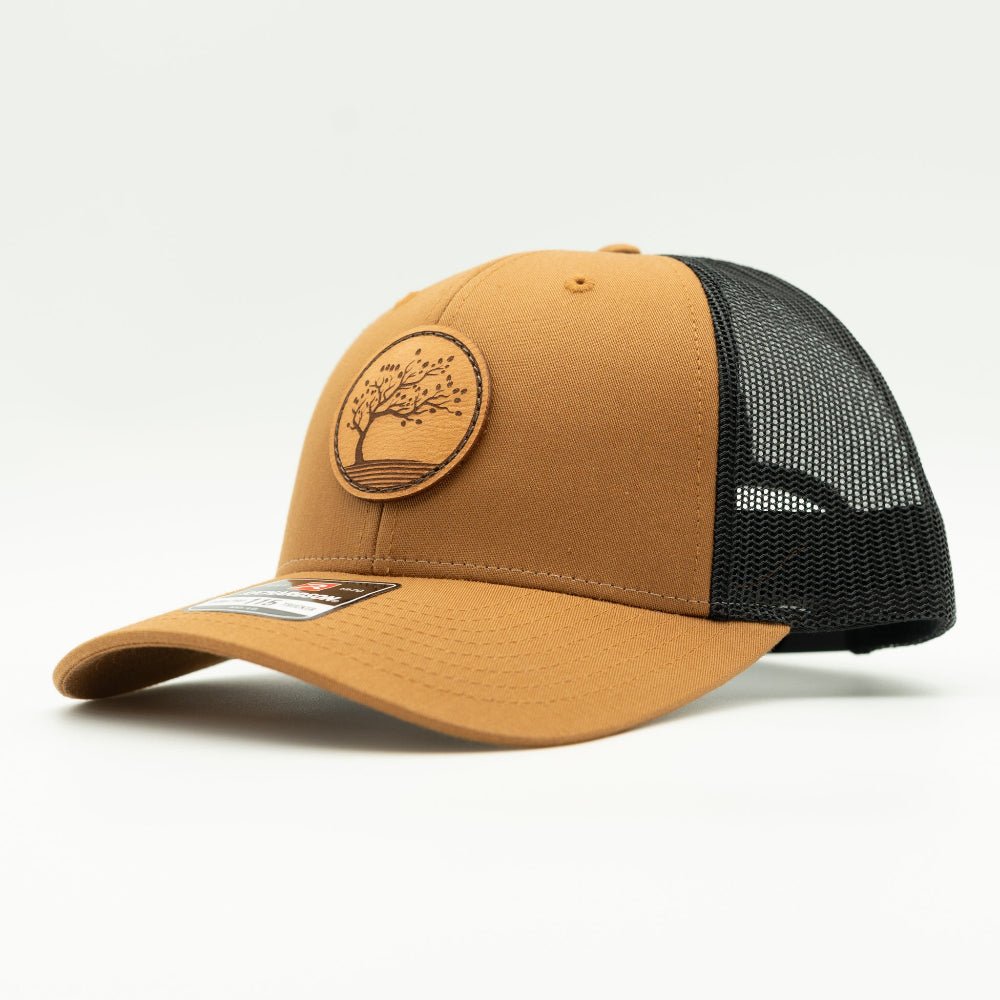 Side view of Carmel Black Richardson 115 low profile trucker hat with caramel front, black mesh and Blossom leather patch.

Color: Caramel/Black