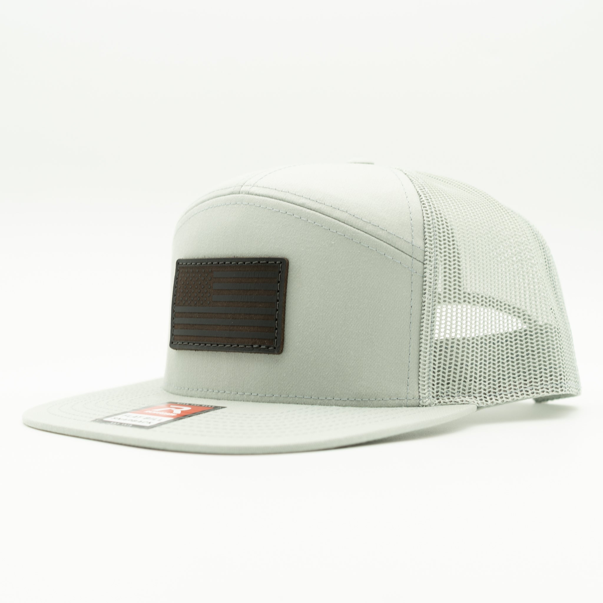 Quarry Richardson 168 seven panel trucker hat with black American Flag leather patch, side view showing flat bill, high profile fit, and mesh back.

Color: Quarry 168 (OSFM)