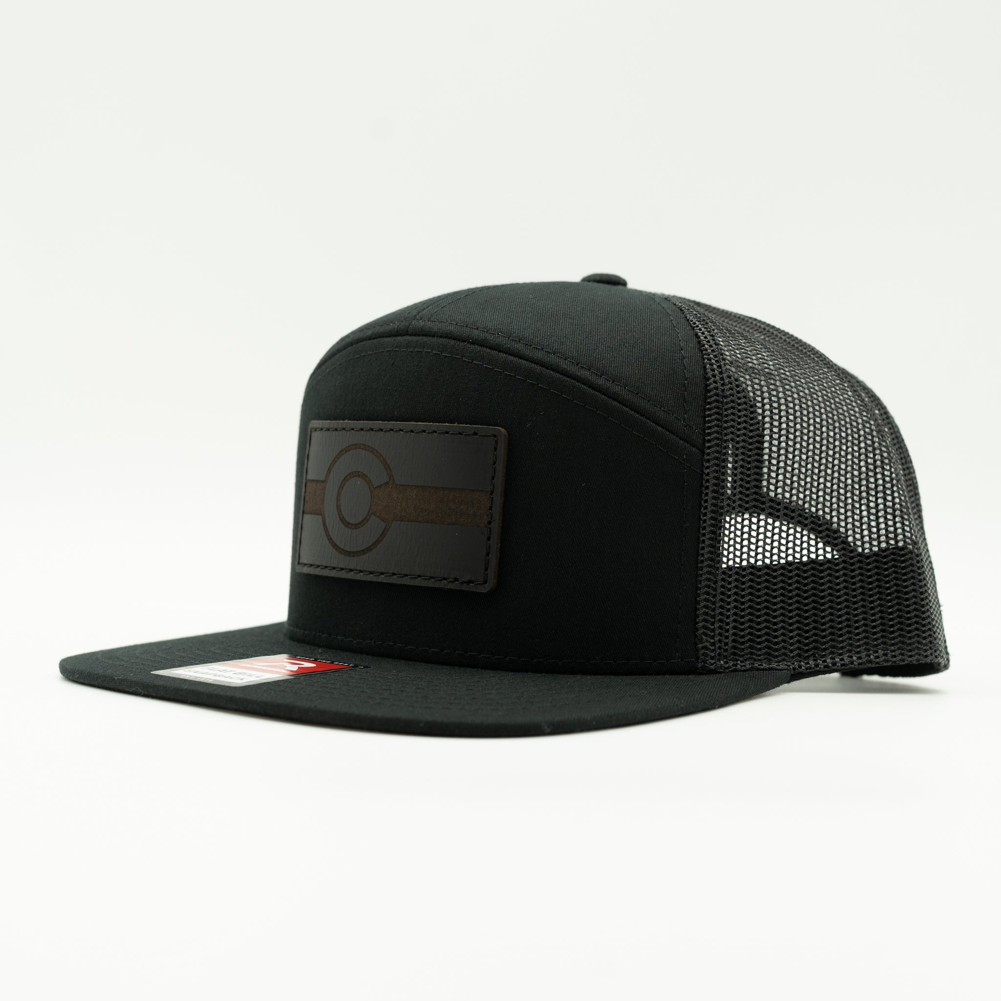 Side view of solid black Richardson 168 seven panel trucker hat with black leather Colorado flag patch, modern Colorado leather patch hat

Color: Black/Black  168 (OSFM)