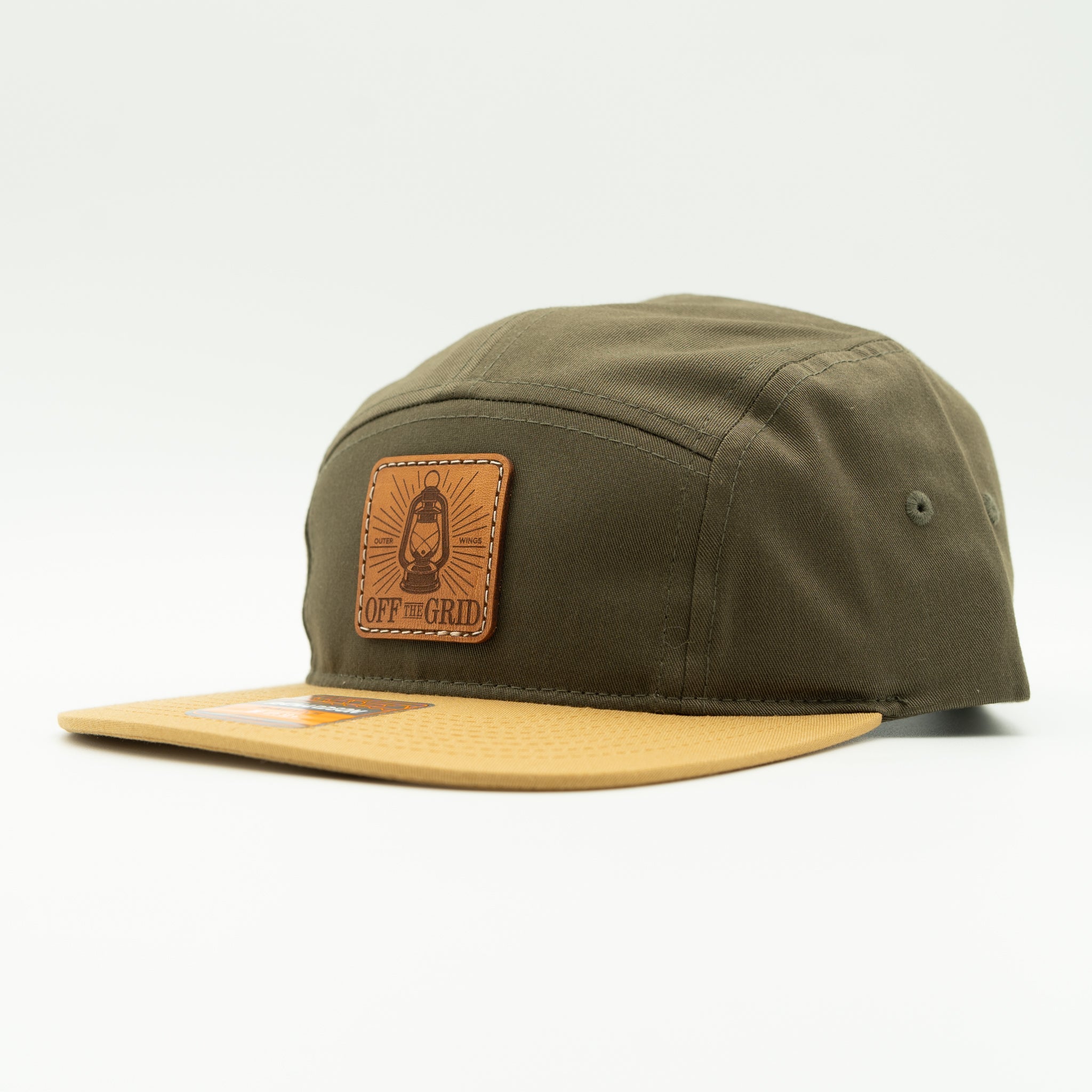 Loden and biscuit Off The Grid Richardson 217 camper hat side view, earth tone leather patch hat with flat bill for off grid trips.