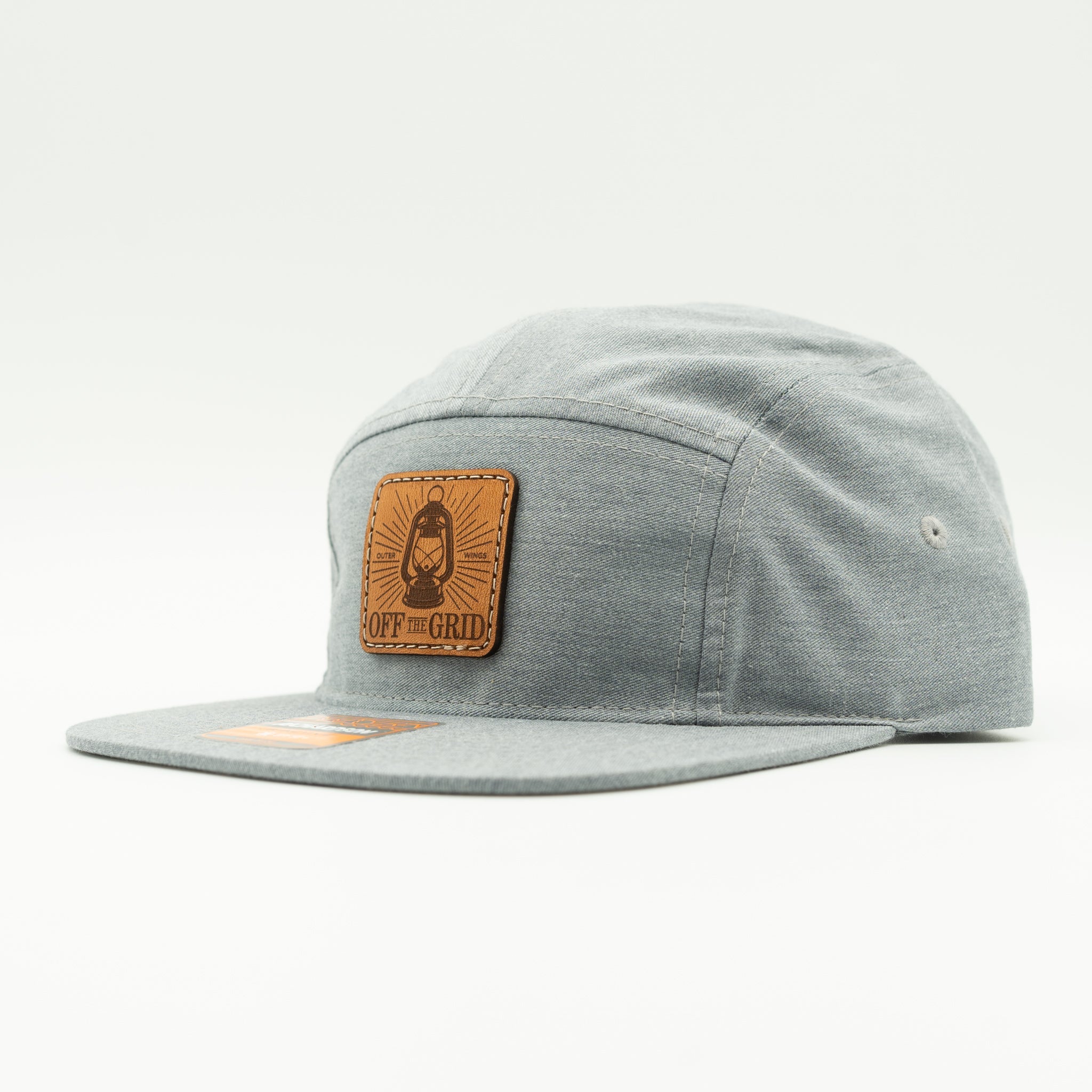 Heather grey Off The Grid Richardson 217 camper hat side view with engraved leather patch and flat bill for city to trail adventures.
