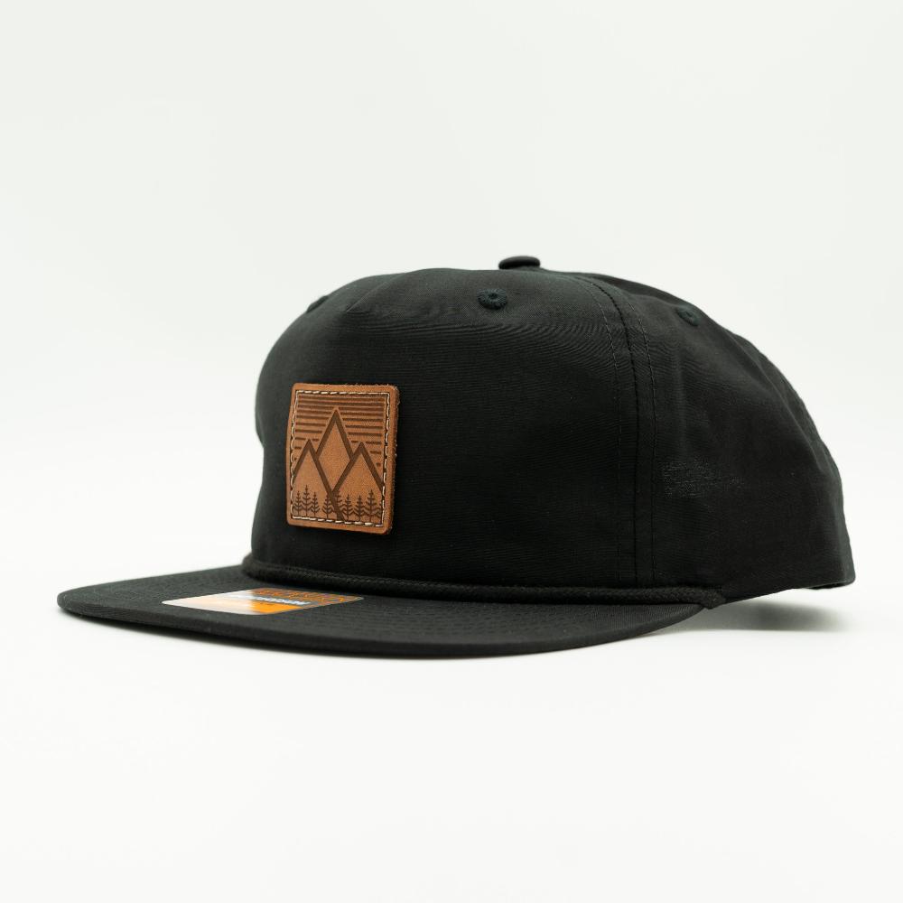 Side view of black Mountain West leather patch rope hat on Richardson 256, highlighting real leather patch, flat rope bill, and lightweight fabric crown.