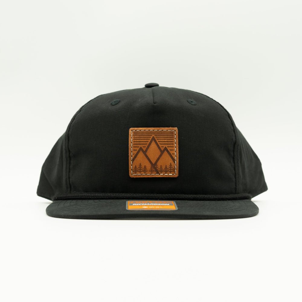 Front view of black Richardson 256 Mountain West rope hat, showing square leather mountain patch, flat bill with rope accent, and low profile mountain hat fit.