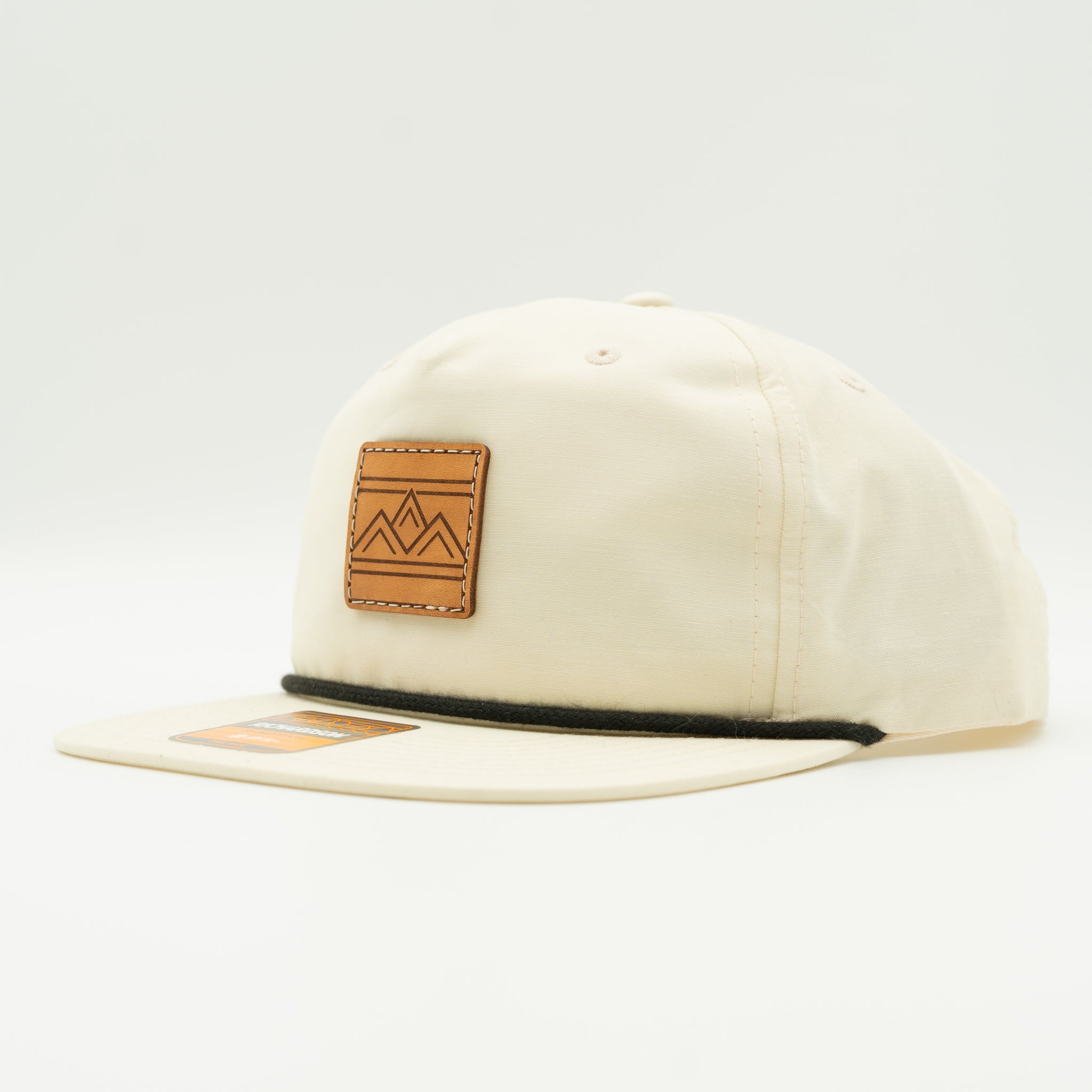 Rustic Ridge birch and black Richardson 256 rope hat side view with light crown, black brim, and sewn leather mountain patch.