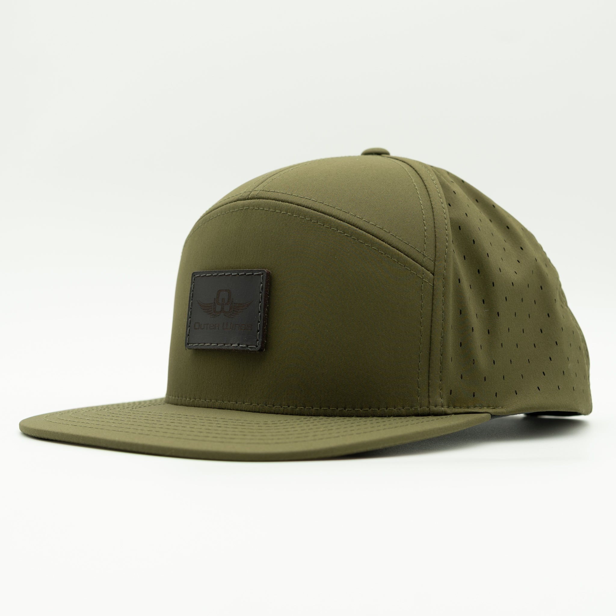 An olive green flat-brim cap with perforated side panels and a dark brown leather patch on the front displaying the 'Outer Wings' logo, set against a plain white background.

Color: Olive