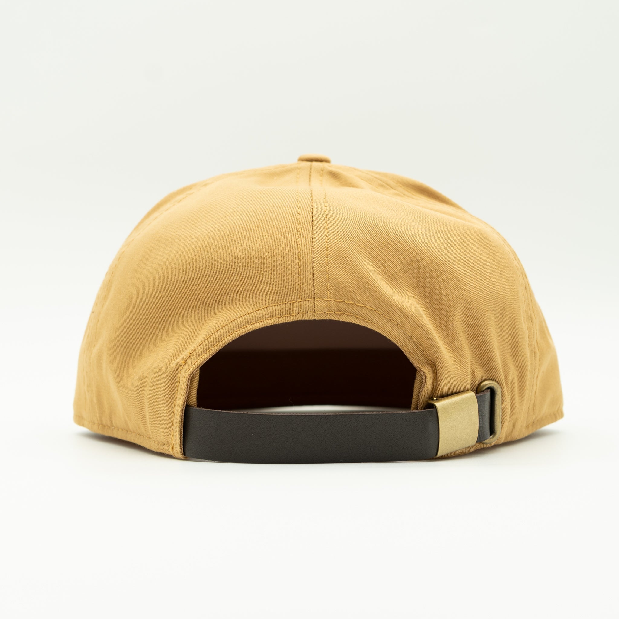 A rear view of a structured baseball cap in a warm mustard yellow color, featuring a black adjustable strap with a gold-tone metal slider, set against a plain white background.

Color: Biscuit