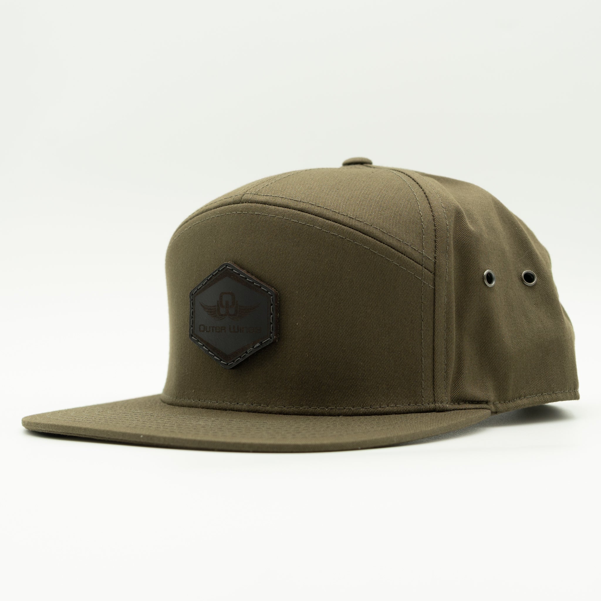 An olive green flat-brim cap with a black hexagonal patch on the front featuring the text 'Outer Wings' and a leather wing logo, photographed on a clean white background.

Color: Olive