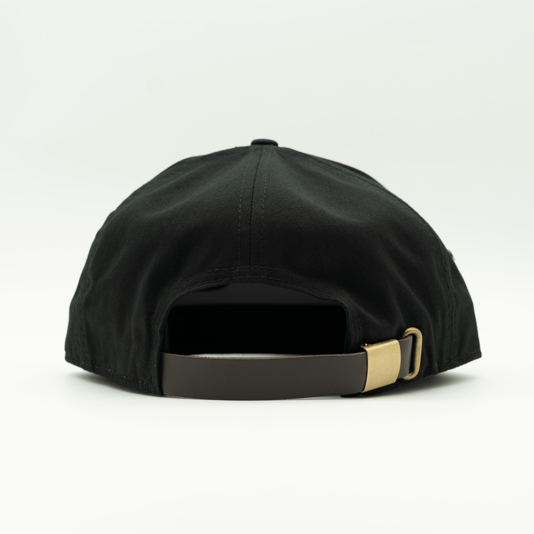 Rear view of a black baseball cap with a dark brown adjustable strap and a gold metal buckle, shown on a clean white background.

Color: Black
