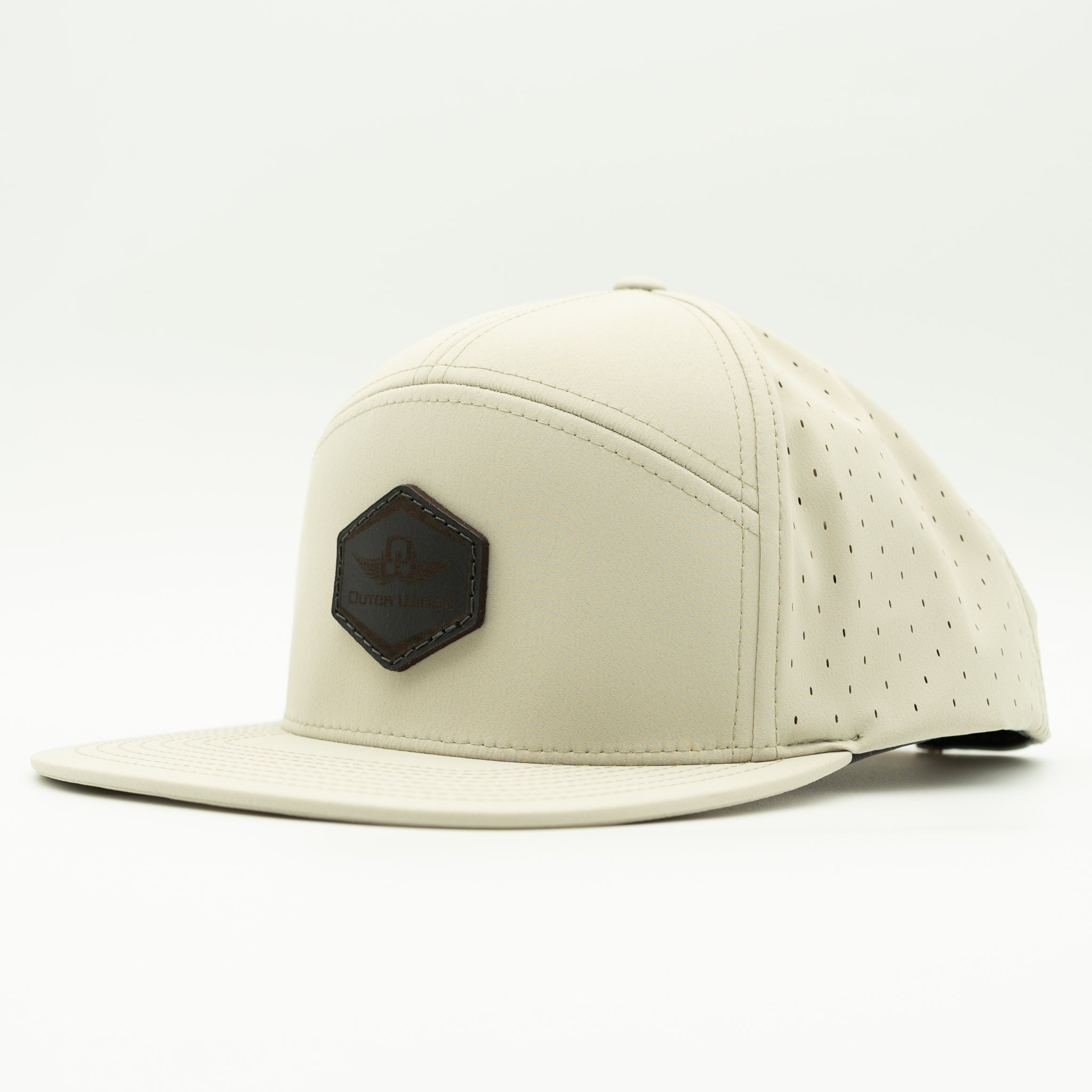 A light beige leather baseball cap with a brown leather patch on the front featuring a mountain and tree design, set against a plain white background.

Color: Ivory
