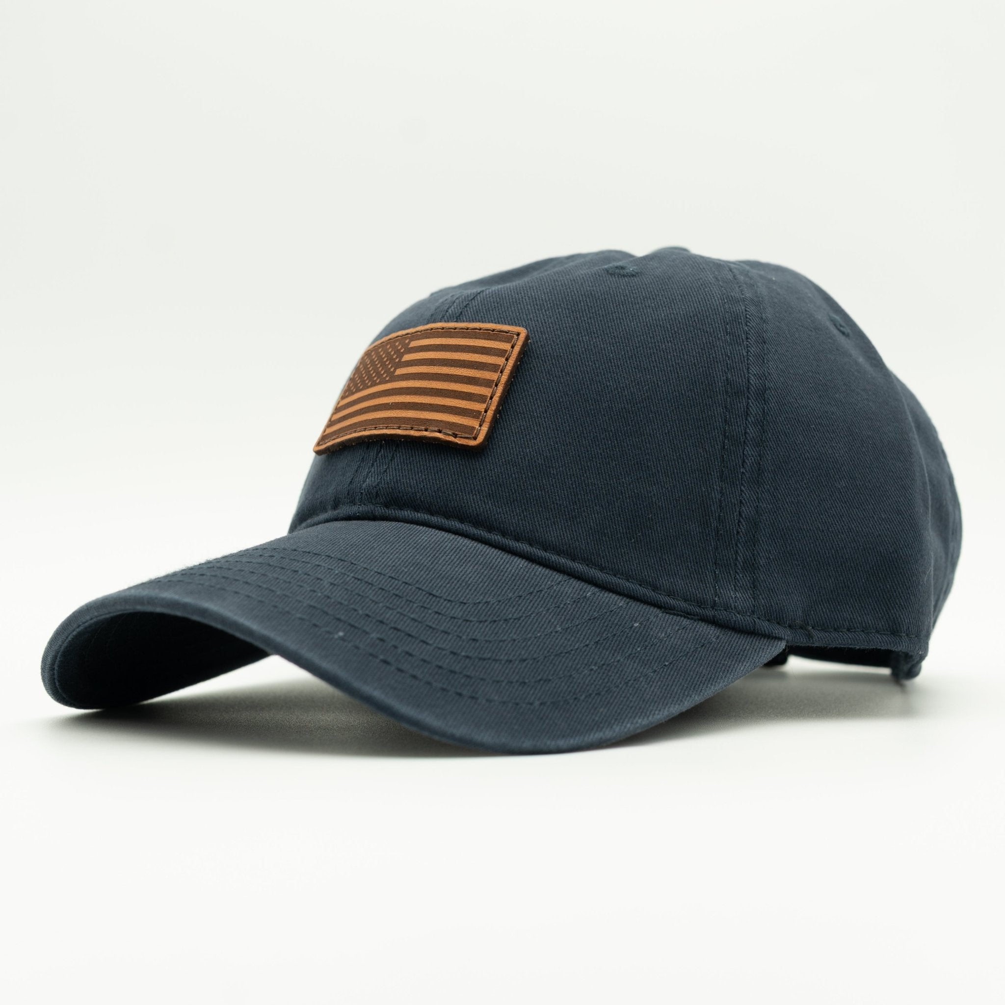Blue baseball cap with a brown flag patch on a white background

Color: Navy