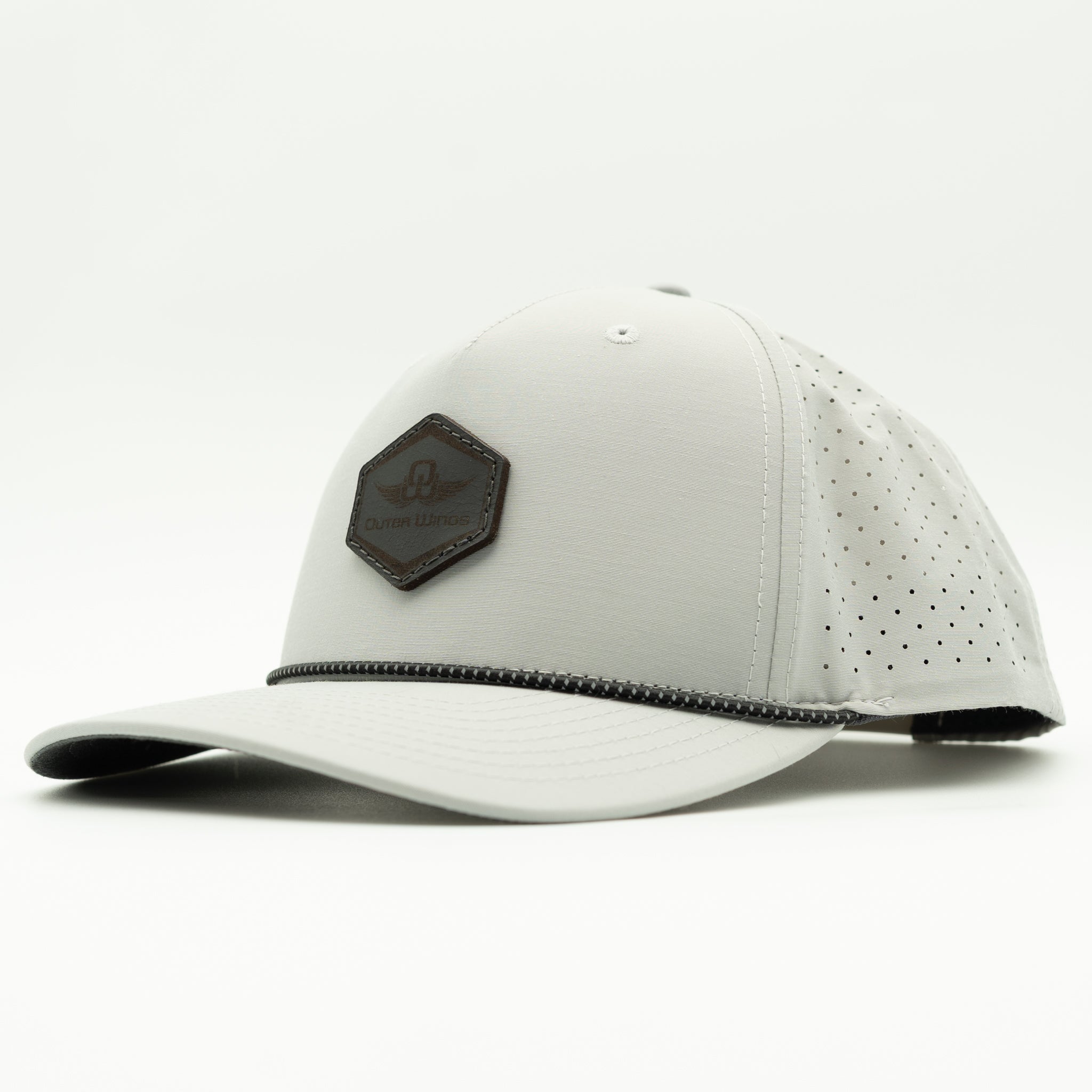 A light gray baseball cap with a Black hexagonal patch on the front, featuring perforated side panels and a curved brim, shown against a plain white background.

Color: Silver