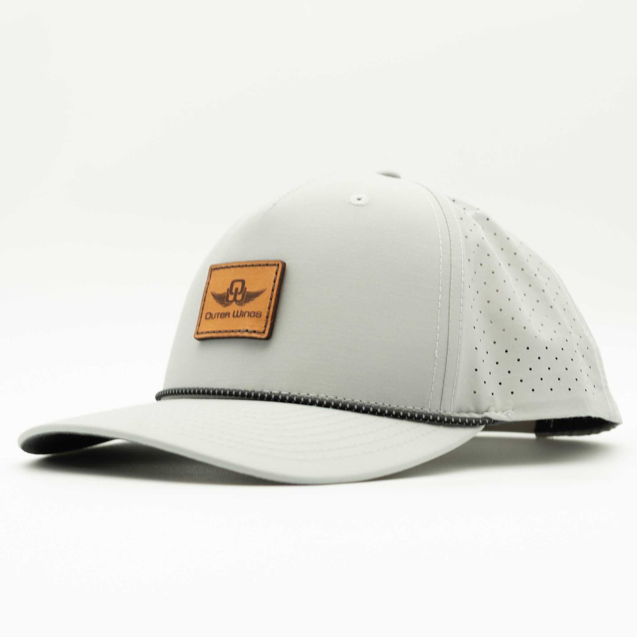 A light gray baseball cap with perforated side panels, a curved brim, and a brown leather patch on the front featuring the brand name 'Outer Wings'.

Color: Silver