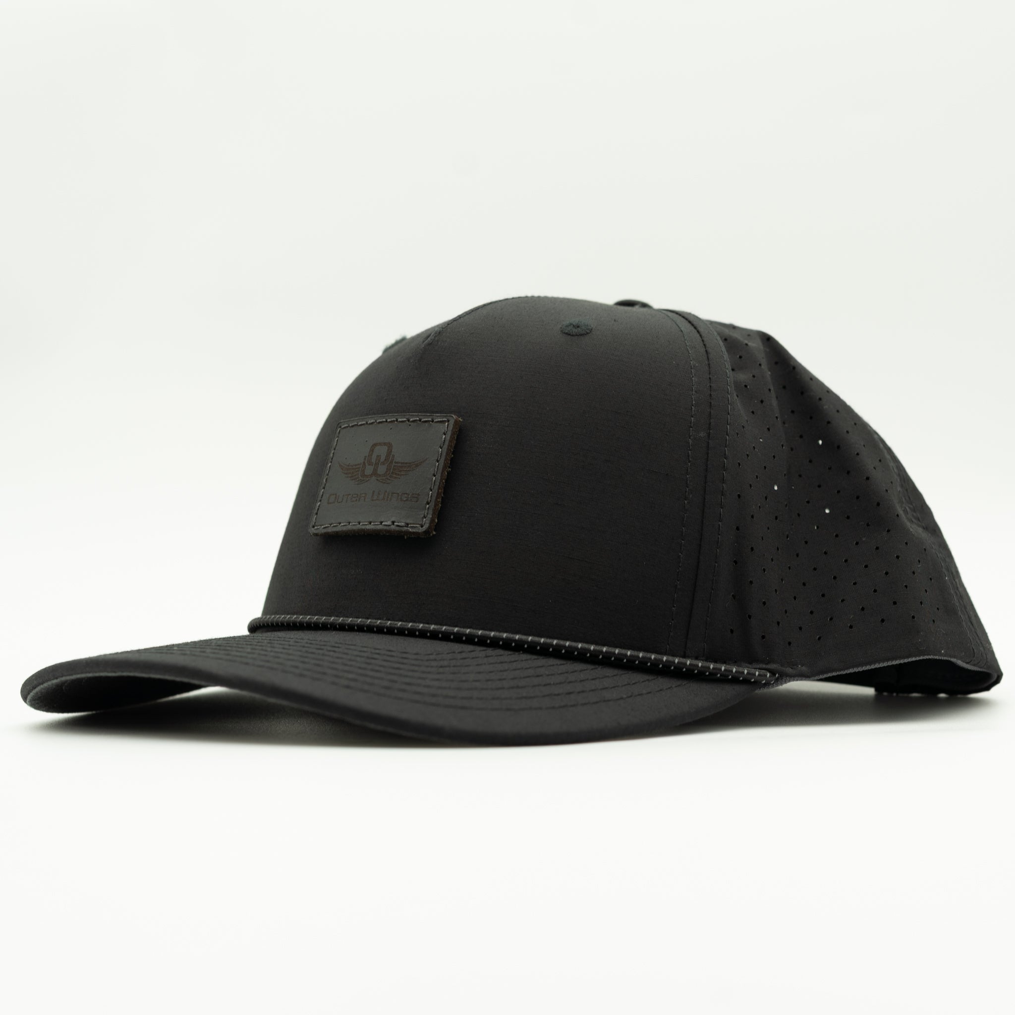 A black baseball cap with a structured crown, perforated side panels, and a curved brim, featuring a Black leather patch on the front with a wing logo and the text 'Outer Wings'.

Color: Black