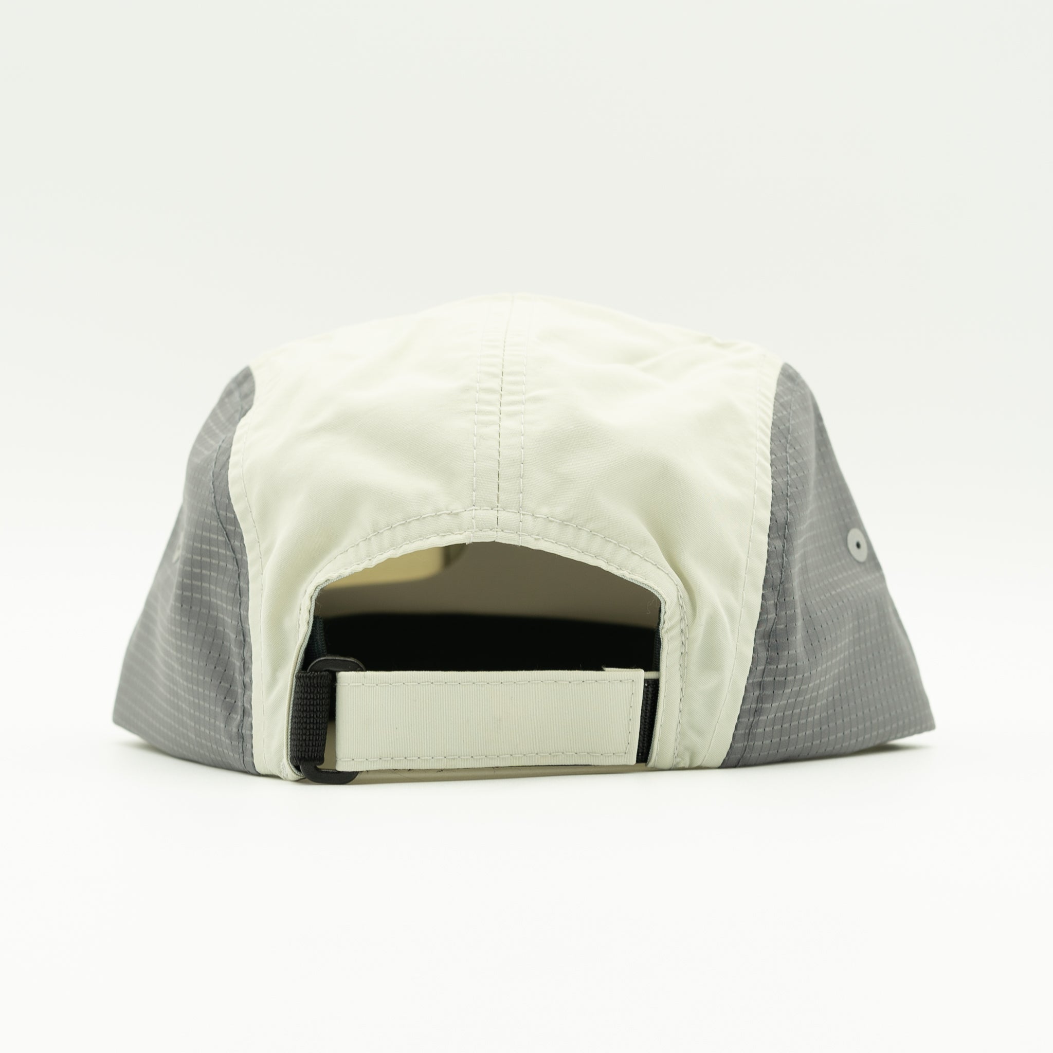 The back view of a lightweight baseball cap in off-white and gray, featuring a breathable mesh side panel and an adjustable snap strap closure.

Color: Light Jade/Charcoal