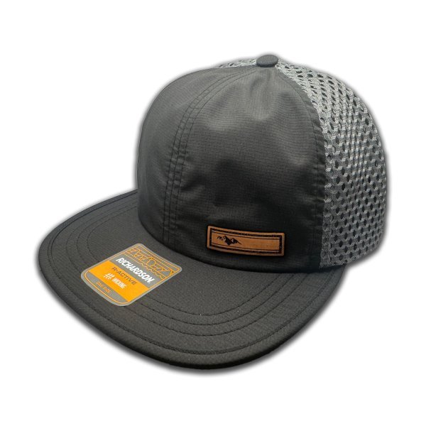 Side view of Richardson 935 hat in black/charcoal, highlighting the Active Mountain leather patch and adjustable backstrap.