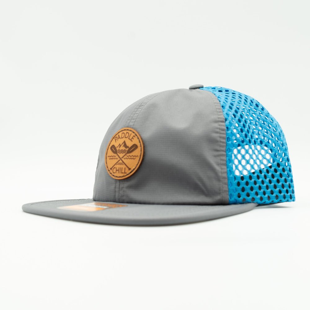Side view of charcoal and cyan Paddle and Chill hat on Richardson 935, bright mesh water sports hat with leather patch and curved bill.