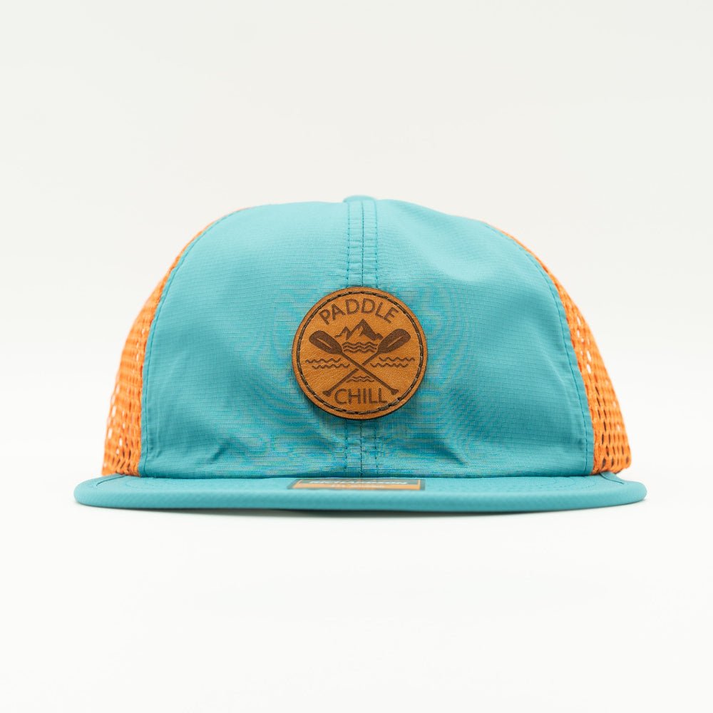 Front view of teal and orange Paddle and Chill circle patch hat, low profile performance cap for paddleboarding, rafting and beach days.