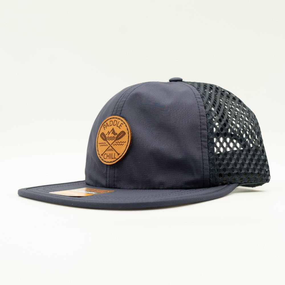 Side angle of navy Paddle and Chill leather patch hat, lightweight water resistant Richardson 935 performance hat for paddleboard and boat trips.