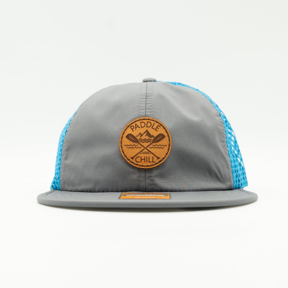 Front view of charcoal and cyan Paddle and Chill leather patch hat, performance paddleboarding cap with circle paddles design and mesh back.