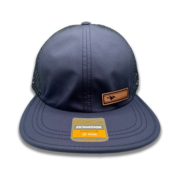 Front view of Richardson 935 hat in navy/navy with Active Mountain leather patch, featuring a full-grain leather patch with a mountain design.