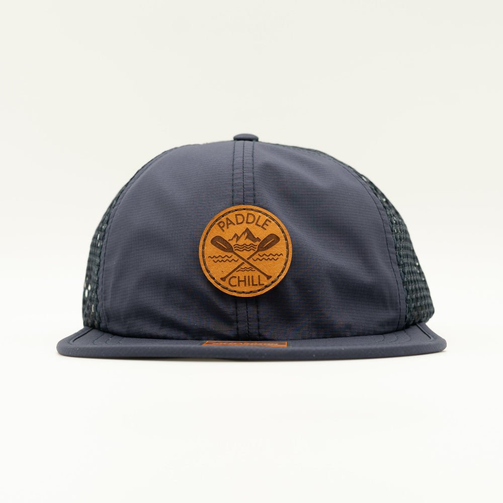 Front view of navy Paddle and Chill circle leather patch hat on Richardson 935, low profile outdoors hat for SUP, kayaking and summer travel.