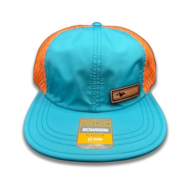 Front view of Richardson 935 hat in teal/orange with Active Mountain leather patch, highlighting the intricate laser-engraved mountain design.