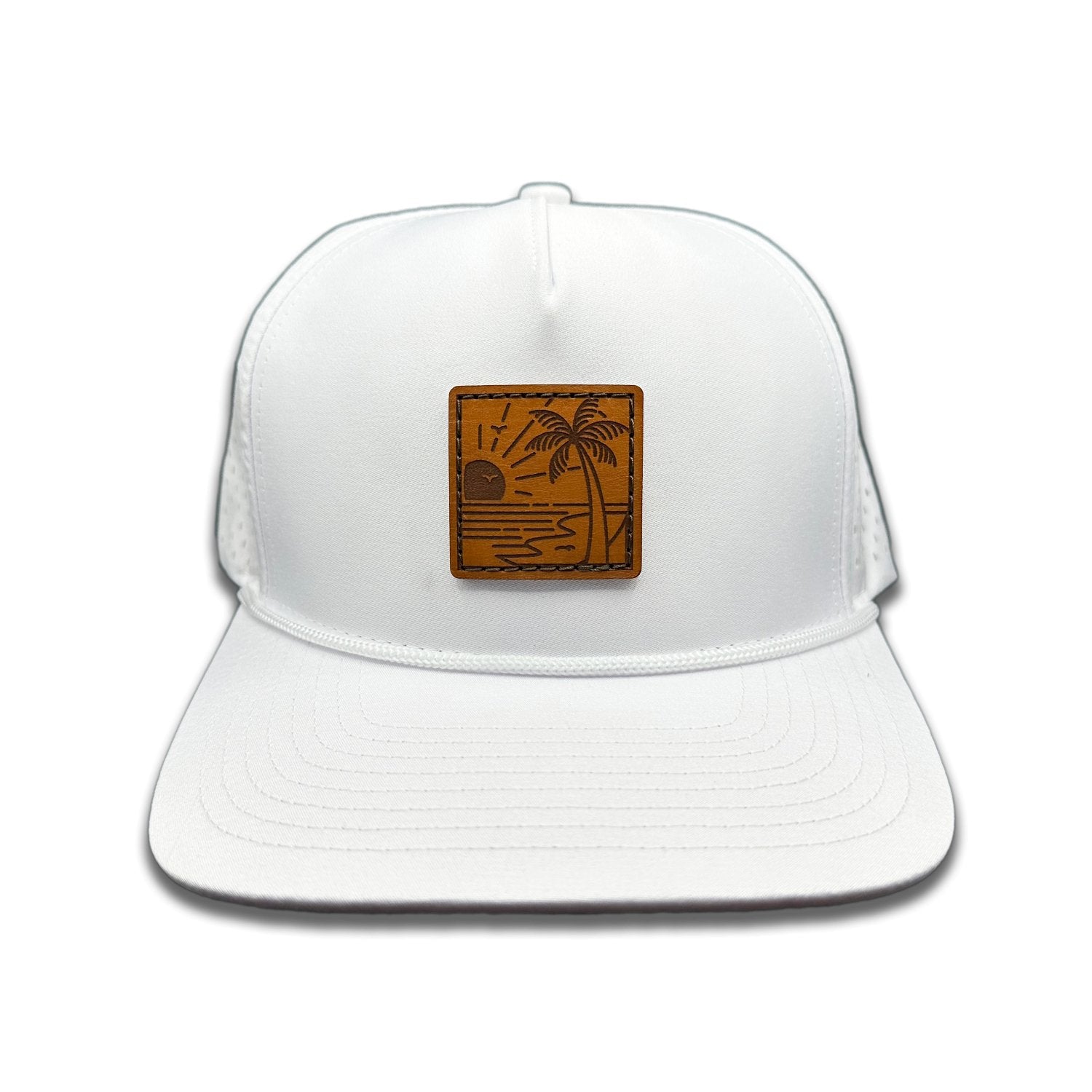 Front view of the Seaside Serenity Leather Patch Hat by Outer Wings in white, featuring a high-profile Outer Wings 970 rope hat with a genuine leather patch showcasing a beachside scene with a sunset and palm trees. Ideal for outdoor enthusiasts and beach lovers.