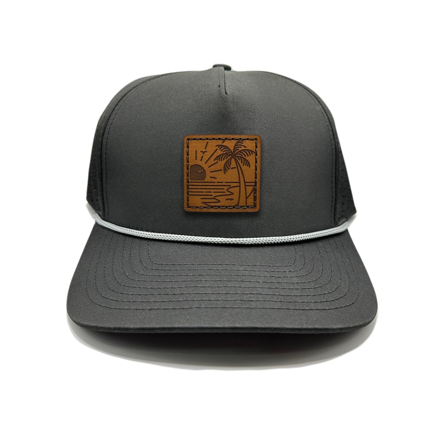 Front view of the Seaside Serenity Leather Patch Hat by Outer Wings in black, crafted on a high-profile Outer Wings 970 rope hat with a genuine leather patch featuring a vintage beachside scene. Perfect for those seeking a custom leather patch hat for outdoor activities.