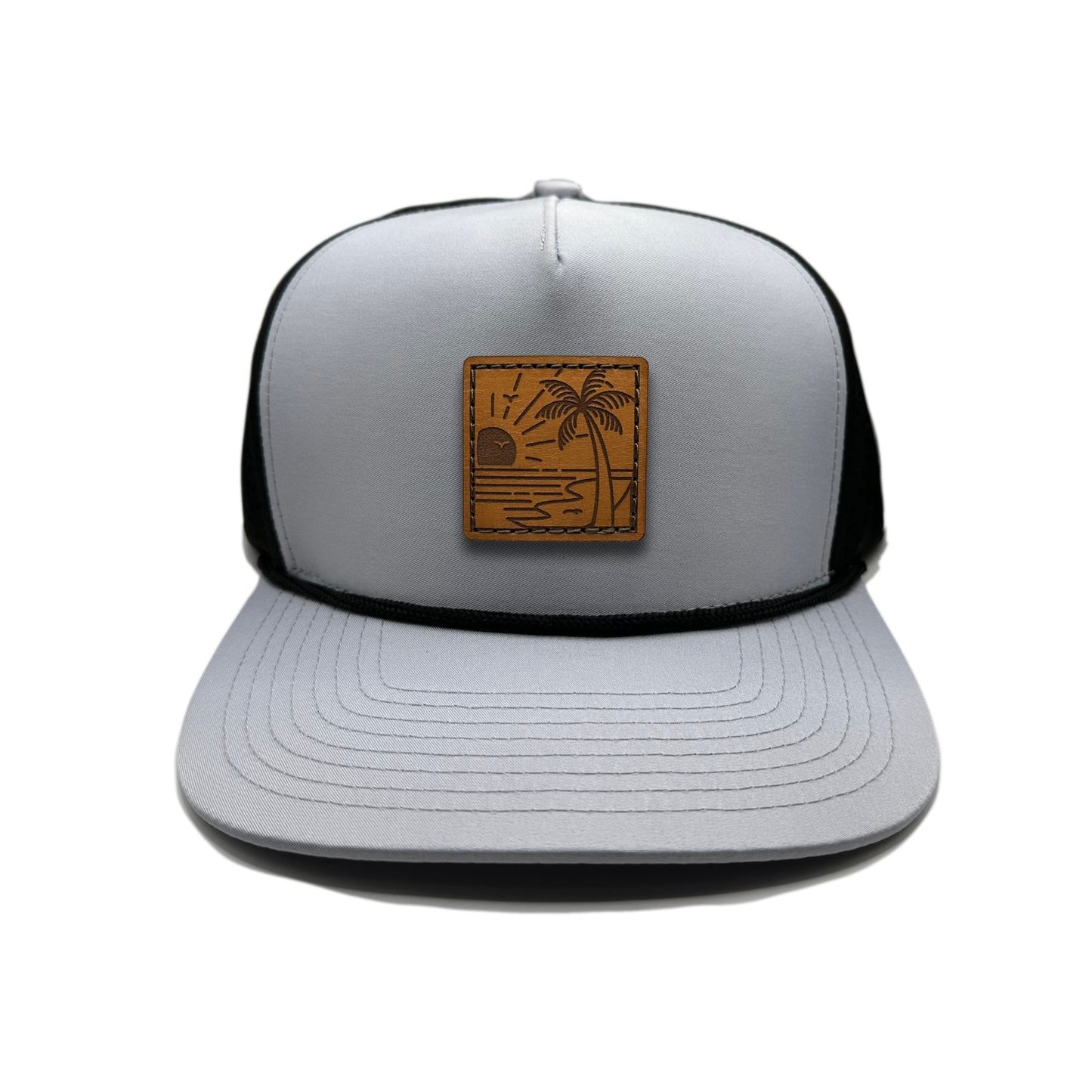 Front view of the Seaside Serenity Leather Patch Hat by Outer Wings in grey/black, featuring a high-profile Outer Wings 970 hat with a leather patch of a beach scene and sunset. A perfect addition to any beach lover’s collection.