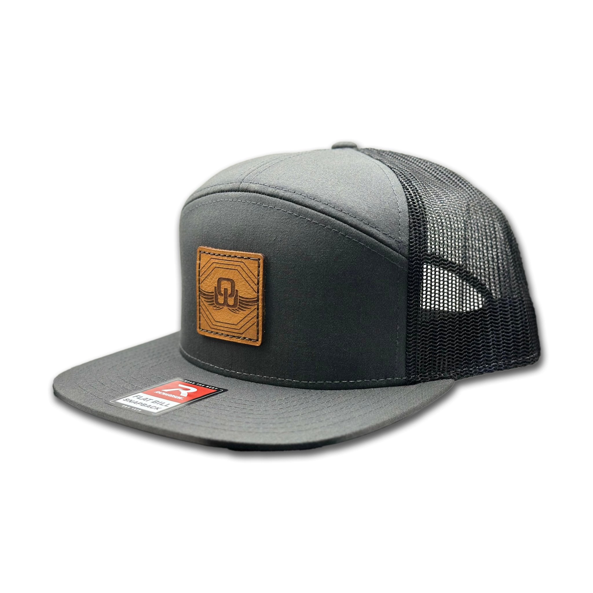 Side view of the Skybound Leather Patch Hat by Outer Wings in Charcoal/Black, showcasing the mesh back, adjustable SnapBack, and structured profile. A versatile outdoors hat for all your adventures.