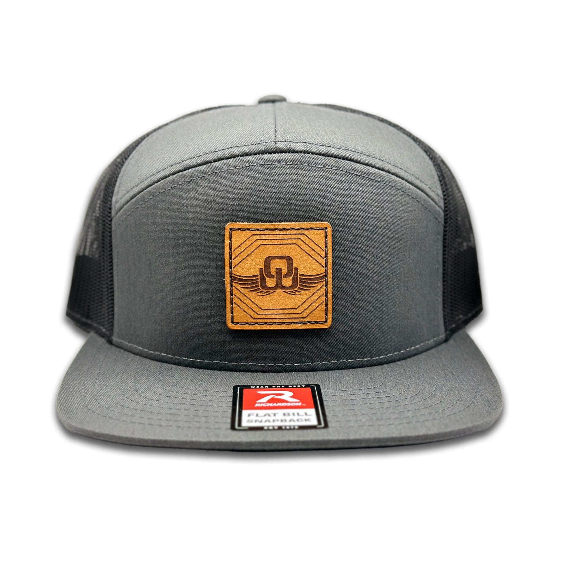 Front view of the Skybound Leather Patch Hat by Outer Wings in Charcoal/Black, crafted on a high-profile Richardson 168 with a seven-panel design and flat bill. The leather patch features the Skybound design, perfect for hiking and everyday wear