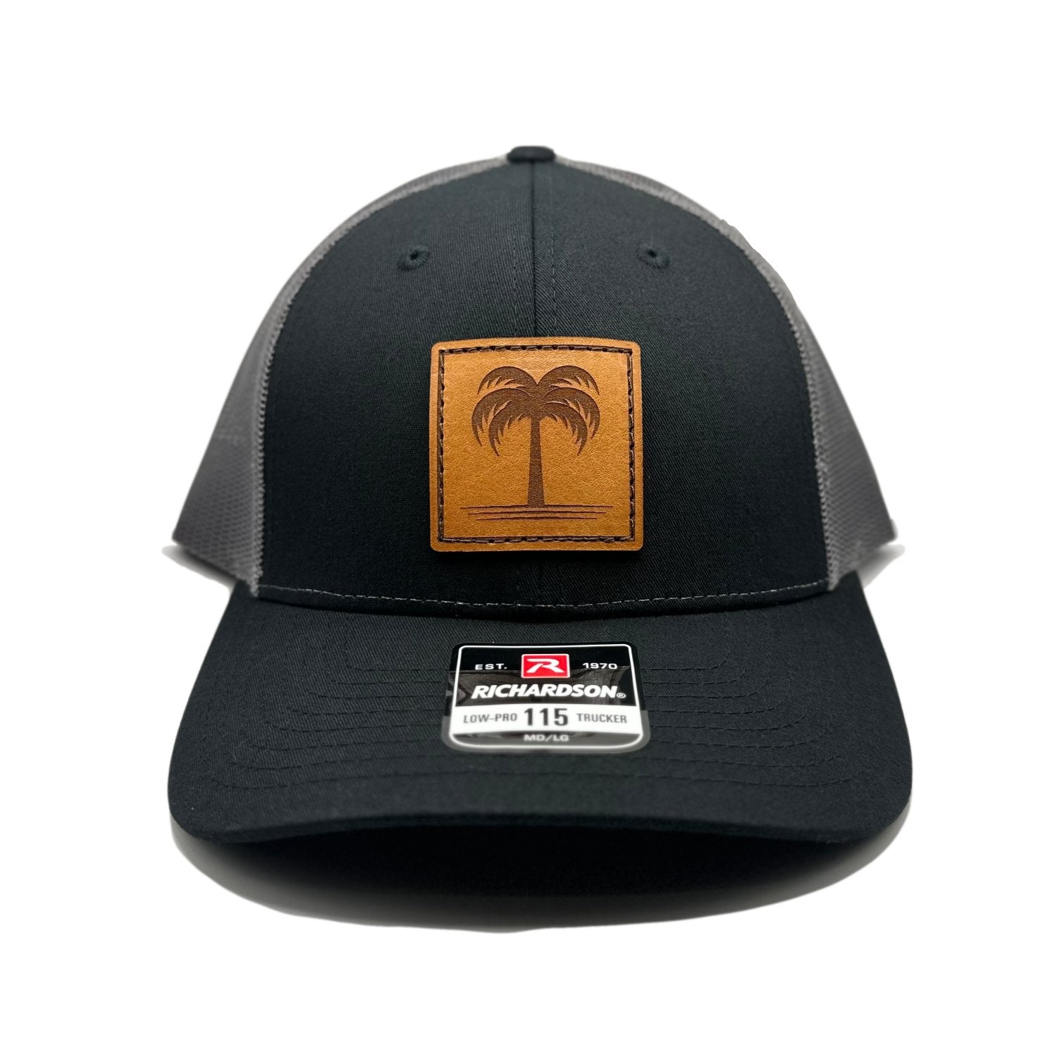 Front view of the Solo Palm Leather Patch Hat by Outer Wings in Black/Charcoal, featuring a low-profile, structured Richardson 115 hat with a hand-sewn leather patch showcasing a palm tree design. Available in M/L size, perfect for adding a touch of tropical style.