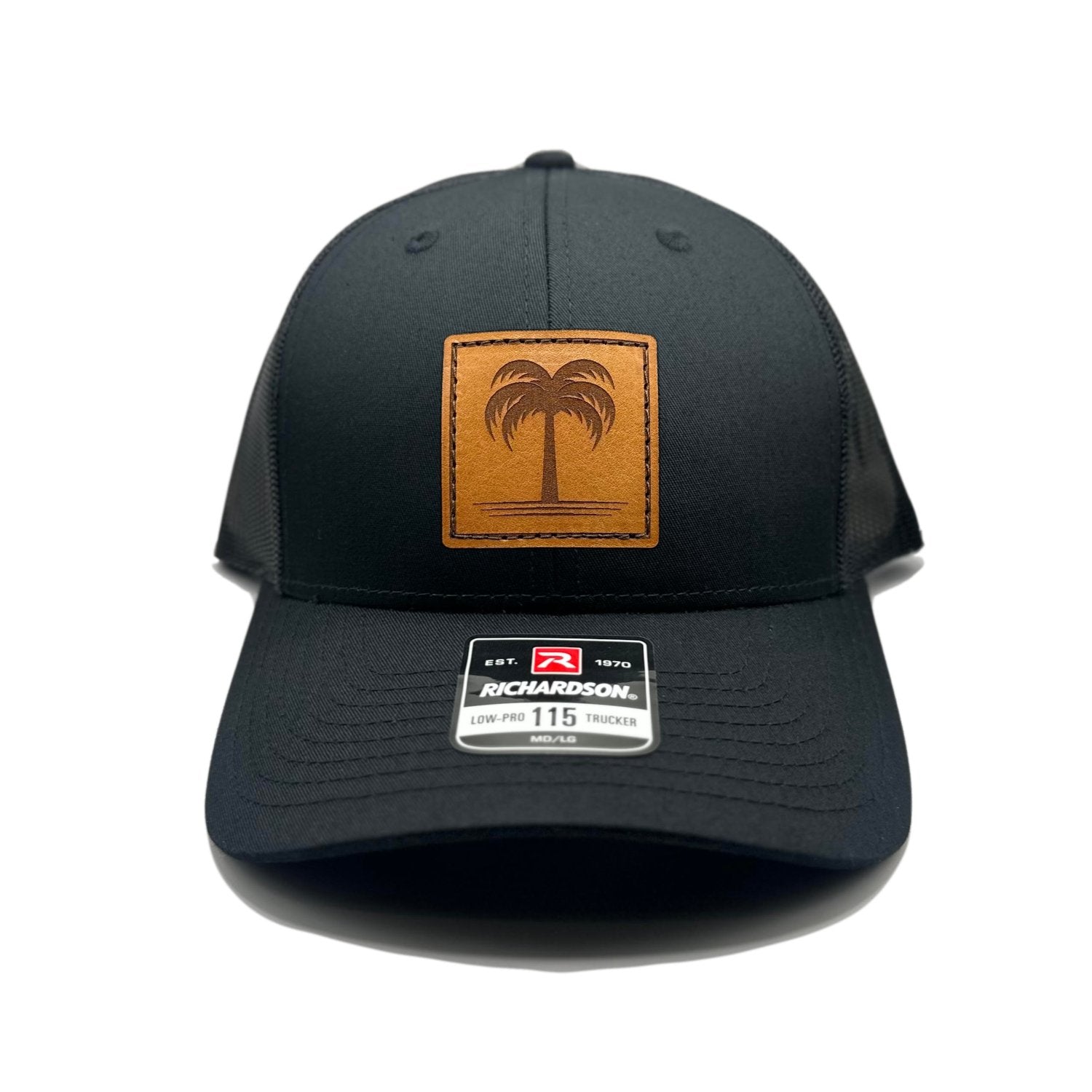 Front view of the Solo Palm Leather Patch Hat by Outer Wings in Black/Black, featuring a low-profile, structured Richardson 115 hat with a hand-sewn leather patch showcasing a single palm tree design. Available in M/L size, ideal for beach lovers and outdoor enthusiasts.