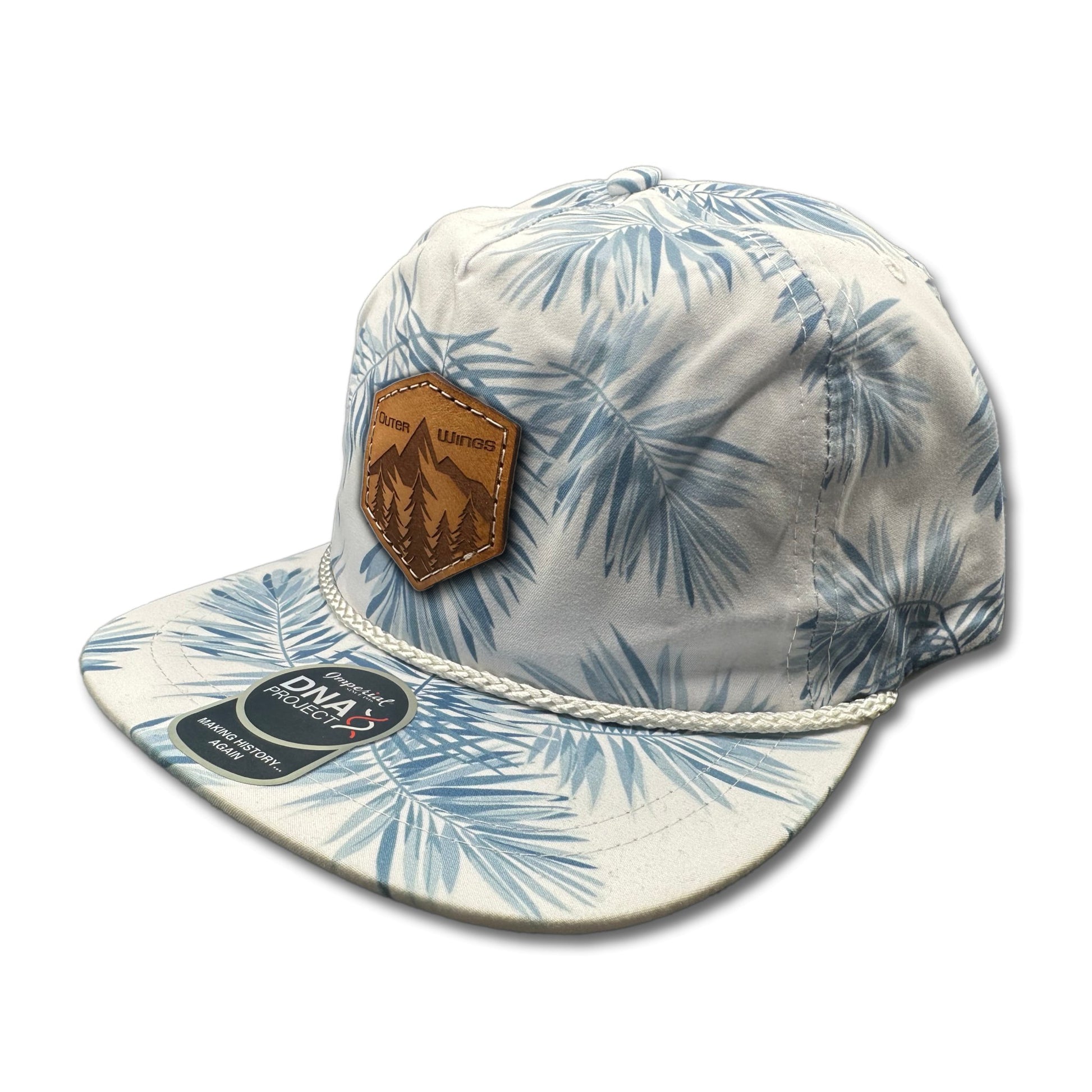 Side view of the Summit Seeker Leather Patch Hat by Outer Wings in White Pine, highlighting the breathable fabric, white rope accent, and adjustable leather strap. A stylish and functional custom leather patch hat for all outdoor adventures.