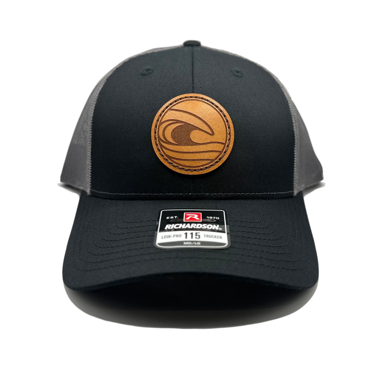 Front view of the Tidal Wave Leather Patch Hat by Outer Wings in Black/Charcoal, crafted on a low profile Richardson 115 with a hand-sewn leather patch featuring an ocean wave design. Available in M/L 