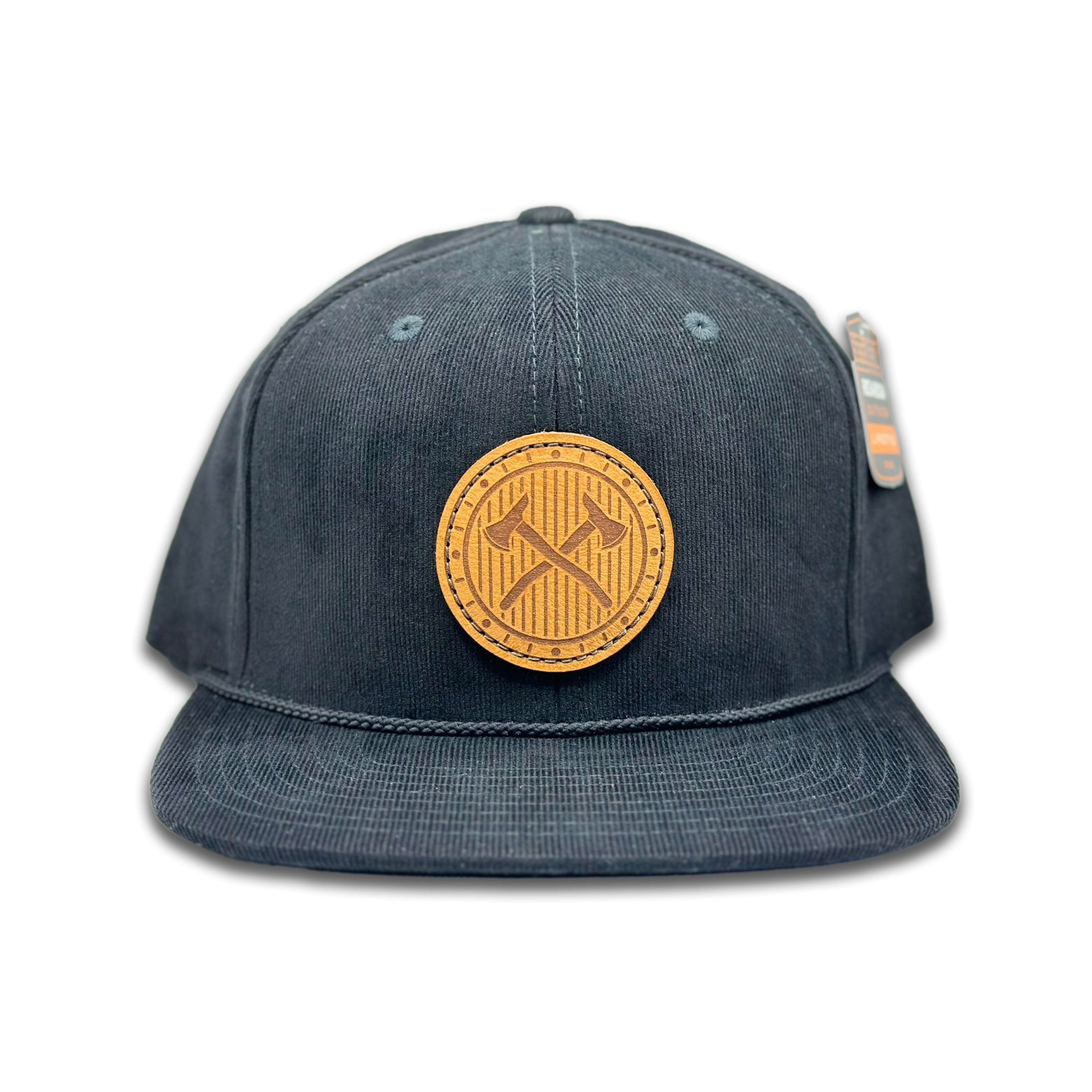 Front view of the Trailblazer Leather Patch Hat by Outer Wings in Black, featuring a high-profile, six-panel Richardson 253 corduroy hat with a hand-sewn leather patch showcasing crossed axes. Perfect for outdoor adventures and casual wear.