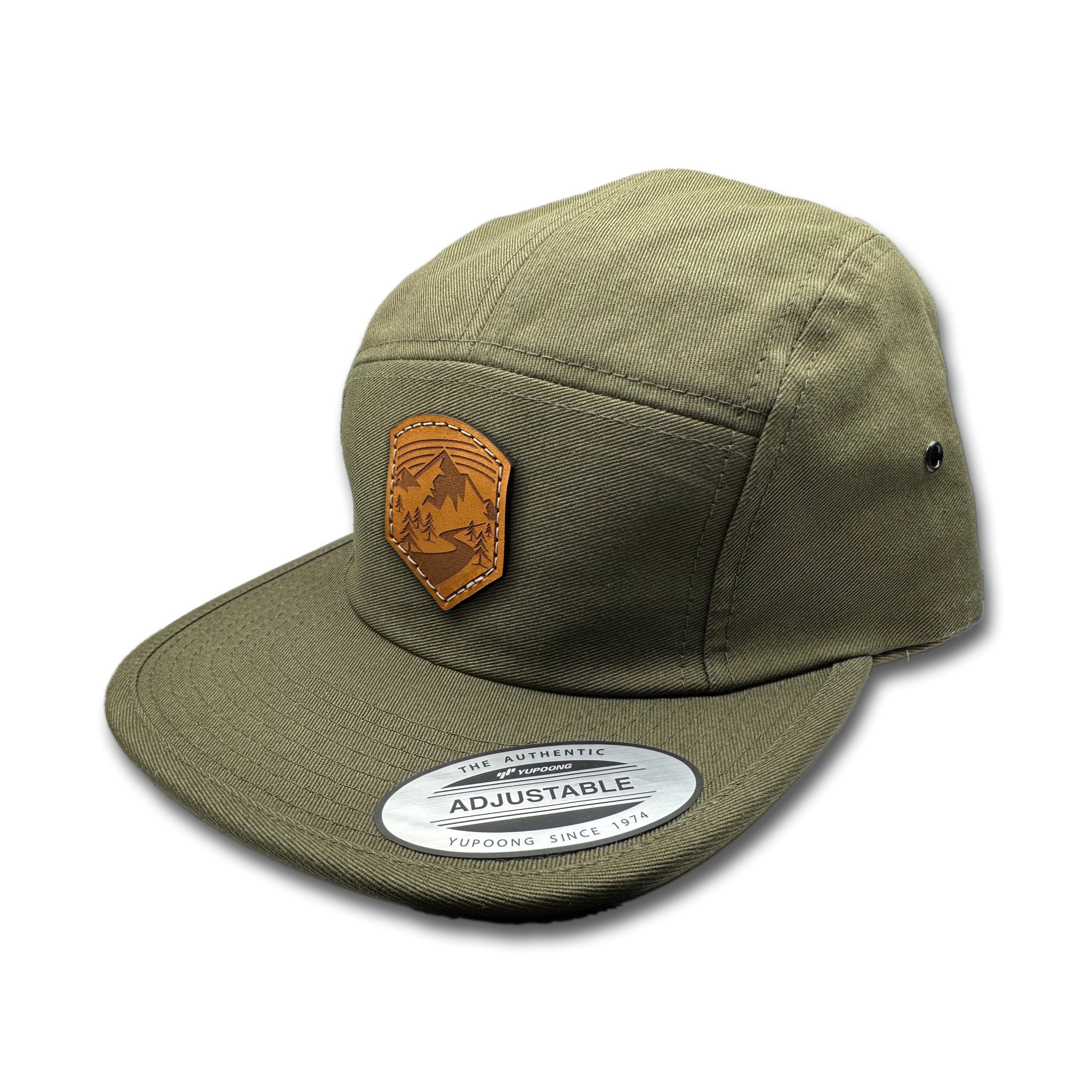 Side view of the Wanderlust Leather Patch Hat by Outer Wings in Olive, highlighting the soft-structured design, flat bill, and adjustable nylon strap closure. A stylish custom leather patch hat for hiking and outdoor activities.