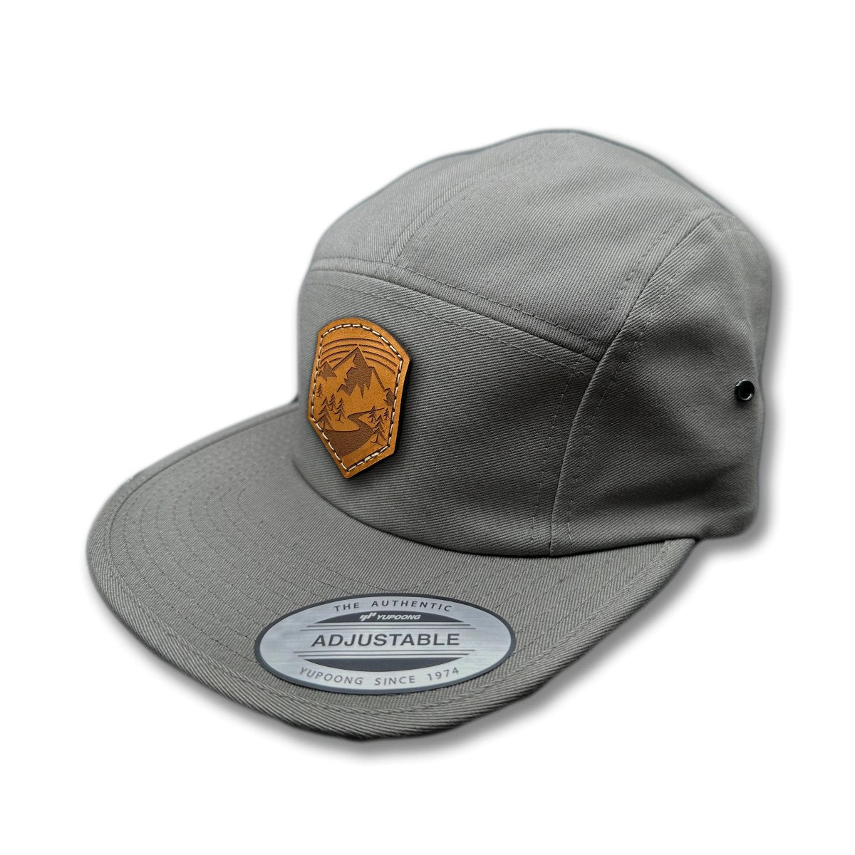 Side view of the Wanderlust Leather Patch Hat by Outer Wings in Dark Grey, showcasing the flat bill, soft-structured profile, and adjustable strap closure. A rugged outdoors hat for all your outdoor adventures.