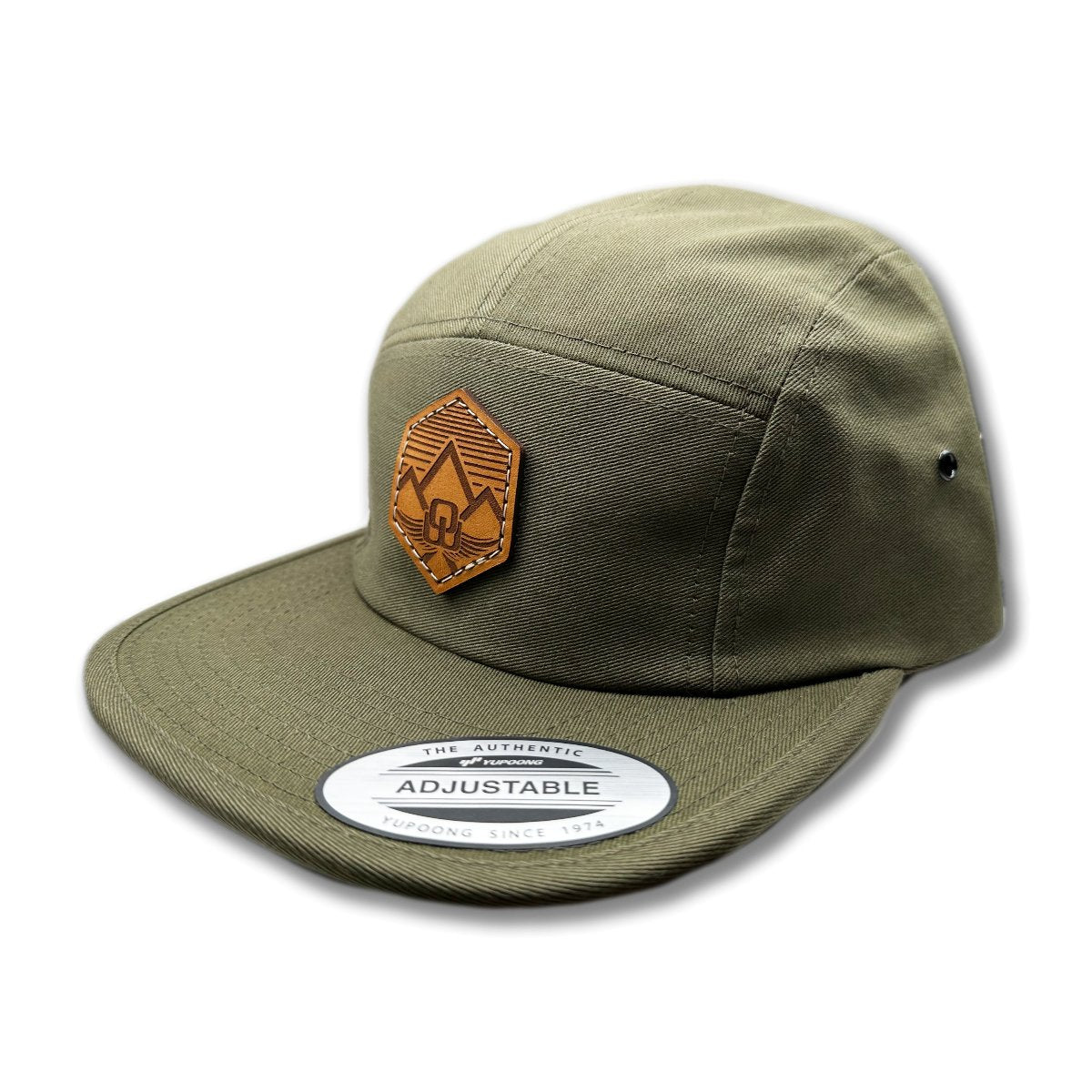 Side view of the Wingrest Leather Patch Hat by Outer Wings in Olive, highlighting the soft-structured design, flat bill, and adjustable nylon strap closure. A stylish custom leather patch hat for hiking and outdoor activities.