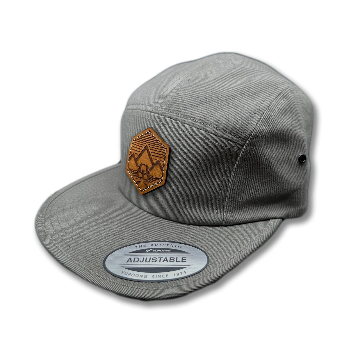 Side view of the Wingrest Leather Patch Hat by Outer Wings in Dark Grey, showcasing the flat bill, soft-structured profile, and adjustable strap closure. A rugged outdoors hat for all your outdoor adventures.