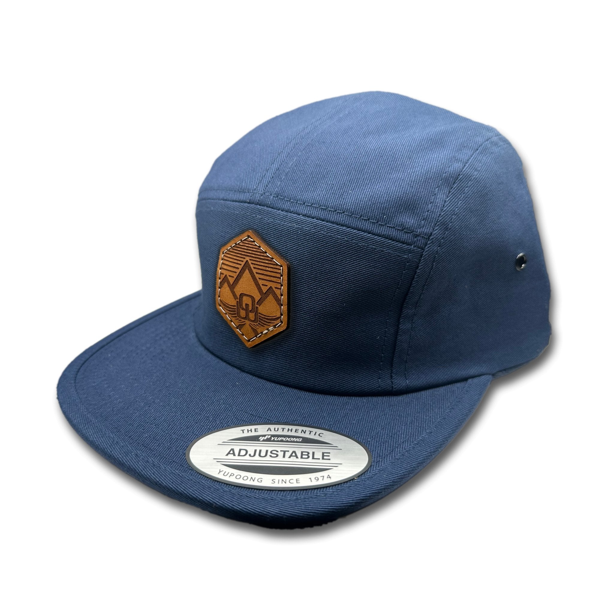 Side view of the Wingrest Leather Patch Hat by Outer Wings in Navy, highlighting the structured design, flat bill, and adjustable strap closure. A durable and stylish custom leather patch hat for outdoor activities and casual wear.