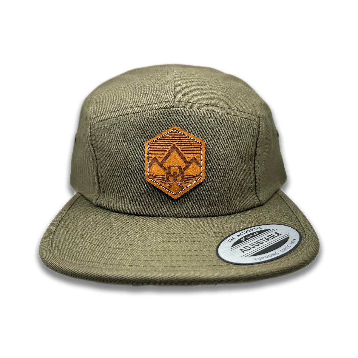 Front view of the Wingrest Leather Patch Hat by Outer Wings in Olive, featuring a low profile, five-panel Yupoong 7005 flat bill hat with a genuine leather patch showcasing a mountain backdrop and the Outer Wings logo. Perfect for outdoor enthusiasts.