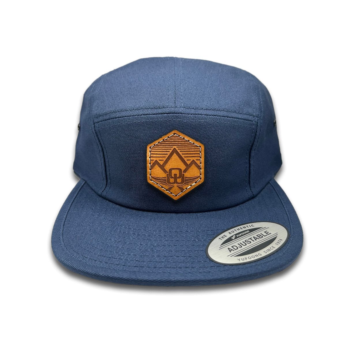 Front view of the Wingrest Leather Patch Hat by Outer Wings in Navy, featuring a low profile Yupoong 7005 jockey hat with a genuine leather patch featuring a mountain backdrop and the Outer Wings logo. Perfect for outdoor enthusiasts.